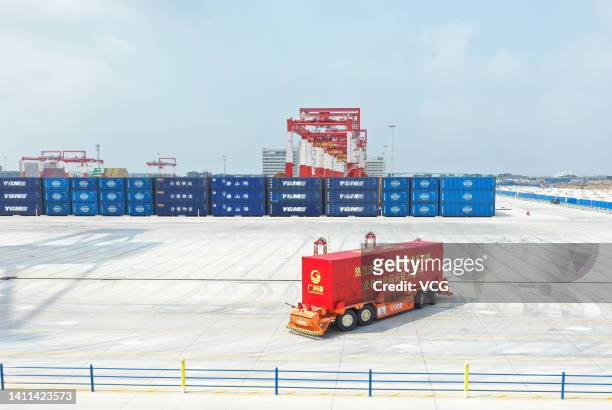 An automatic guided vehicle transports a shipping container at a new fully automated container terminal of Nansha Port on July 28, 2022 in Guangzhou,...