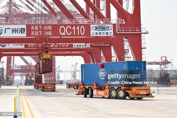 Automatic guided vehicles transport shipping containers at a new fully automated container terminal of Nansha Port on July 28, 2022 in Guangzhou,...