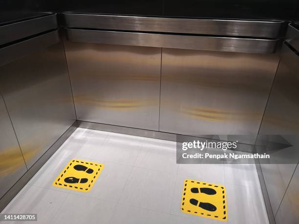 footprint symbols on the floor, distance in lift - social distancing elevator stock pictures, royalty-free photos & images