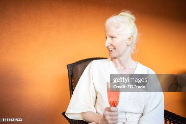mature woman drinking champagne at a beauty spa - albino stock pictures, royalty-free photos & images