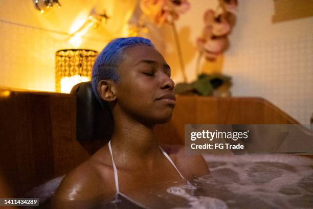 young woman on a bathtube at a beauty spa - bathtube stock pictures, royalty-free photos & images