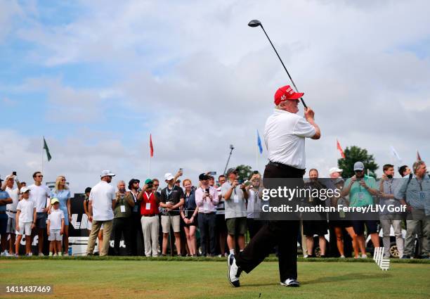 Former U.S. President Donald Trump watches his shot from the first tee during the pro-am prior to the LIV Golf Invitational - Bedminster at Trump...