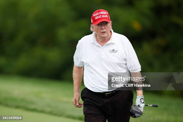 Former U.S. President Donald Trump reacts after his shot from the second tee during the pro-am prior to the LIV Golf Invitational - Bedminster at...