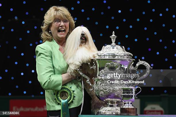 Elizabeth, a Lhasa Apso and owner Margaret Anderson pose for photographs after winning 'Best in Show' at the 2012 Crufts dog show at the National...