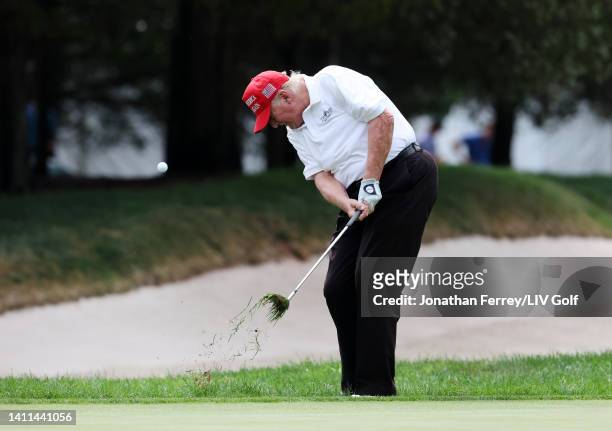 Former U.S. President Donald Trump chips to the second green during the pro-am prior to the LIV Golf Invitational - Bedminster at Trump National Golf...