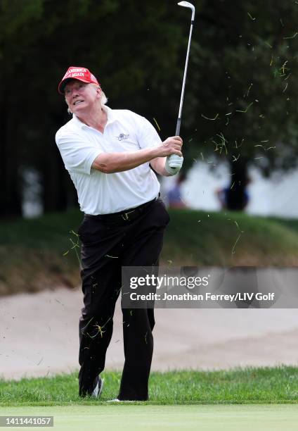 Former U.S. President Donald Trump chips to the second green during the pro-am prior to the LIV Golf Invitational - Bedminster at Trump National Golf...