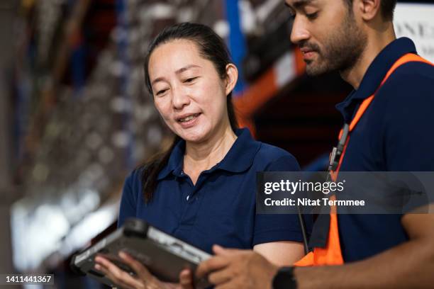increase warehouse employee productivity and efficiency in a logistics supply chain. a front-line warehouse manager and engineer discussed over a tablet computer about warehouse operations improvement to reduce handling and costs. - frontline worker stock pictures, royalty-free photos & images
