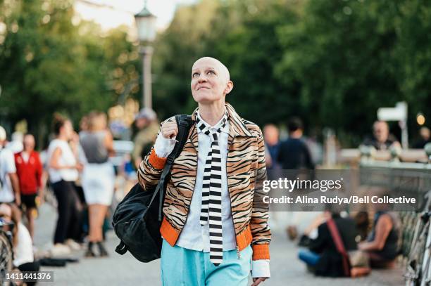 young woman walking on a crowded bridge - eccentric ストックフォトと画像