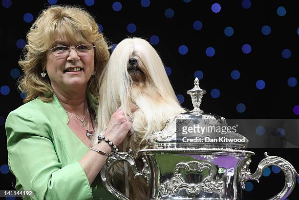 Elizabeth, a Lhasa Apso and owner Margaret Anderson pose for photographs after winning 'Best in Show' at the 2012 Crufts dog show at the National...