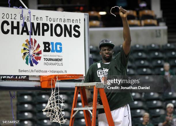 Draymond Green of the Michigan State Spartans celebrates after he cut down a piece of the net following their 68-64 win against the Ohio State...