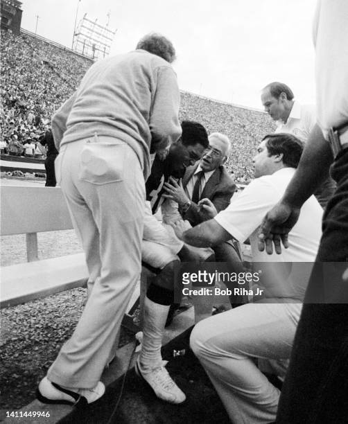 Raiders RB Marcus Allen is tended to by medical personnel and Dr. Frank Jobe after being injured during AFC Playoff game, January 15, 1983 in Los...