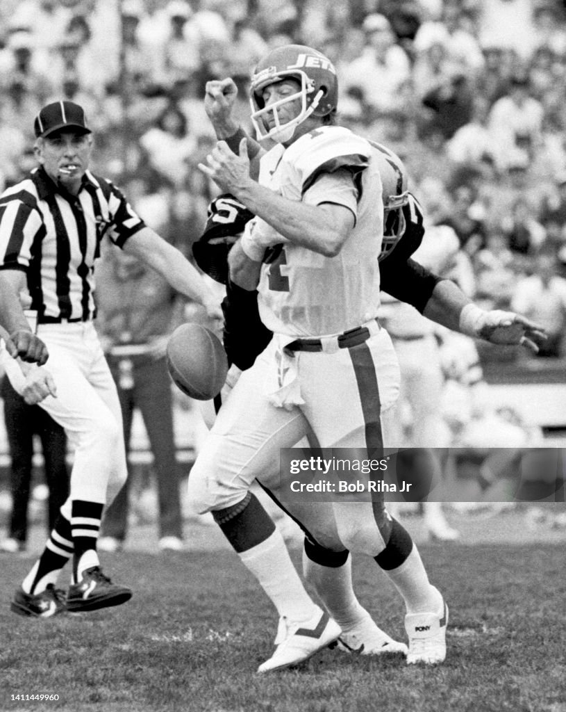 Howie Long tackles Richard Todd during AFC Playoffs - Raiders v. Jets