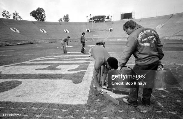 Super Bowl Grounds crew paint the NFL logo and end zones prior to Super Bowl game between Los Angeles Rams and Pittsburgh Steelers, January 18, 1980...