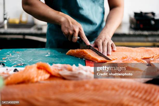 the chef is filleting fresh salmon in the kitchen high resolution stock photo - salmão imagens e fotografias de stock