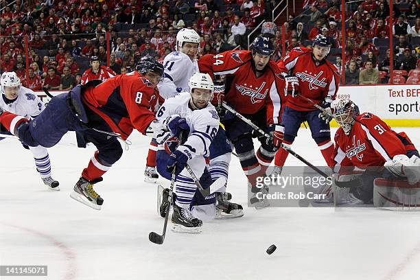 Clarke MacArthur of the Toronto Maple Leafs passes the puck in front of Alex Ovechkin of the Washington Capitals during the second period at the...