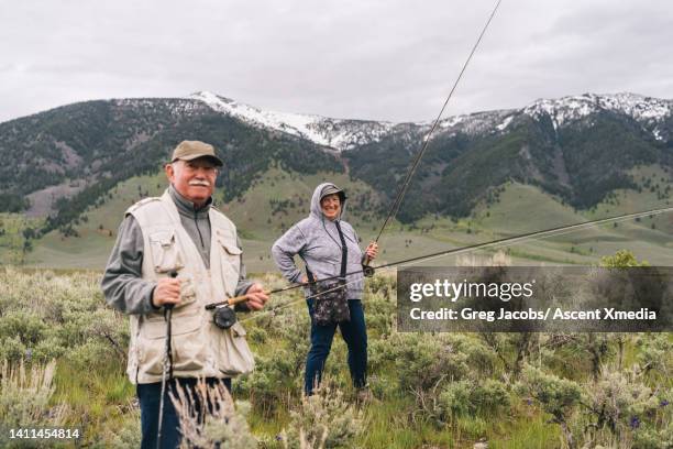 portrait of senior couple with fishing gear - old person with walking stick outside standing stock pictures, royalty-free photos & images