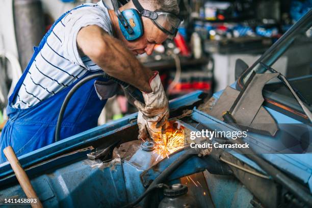 auto mechanic working in home workshop - cluj-napoca romania stock pictures, royalty-free photos & images