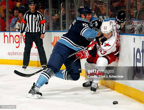 Ed Jovanovski of the Florida Panthers checks Jeff Skinner of the Carolina Hurricanes at the BankAtlantic Center on March 11, 2012 in Sunrise, Florida.