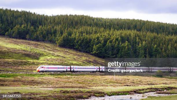 high speed azuma train in scottish countryside - scotland train stock pictures, royalty-free photos & images
