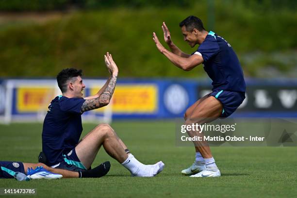 Alessandro Bastoni of FC Internazionale and Alexis Sanchez of FC Internazionale gesture during the FC Internazionale training session at the club's...