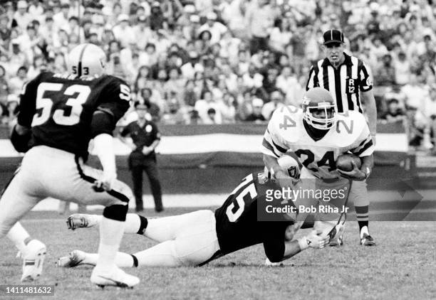Jets RB Freeman McNeil runs and is tackled by Raiders Howie Long during AFC Playoff game, January 15, 1983 in Los Angeles, California.