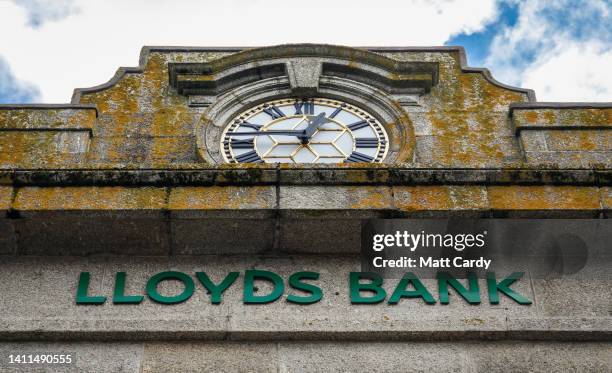 Clock is displayed on the outside of a branch of the bank Lloyds Bank on May 31, 2022 in Penzance, England. Founded in Birmingham in 1765, Lloyds...