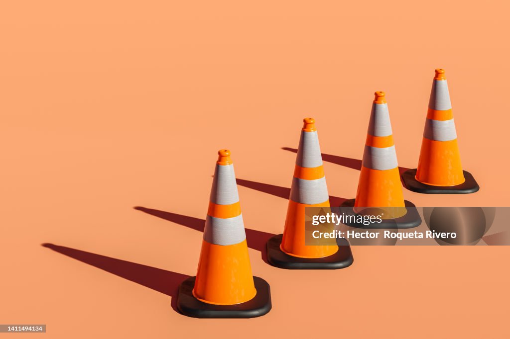 3d render of many Traffic Cones on Orange Background
