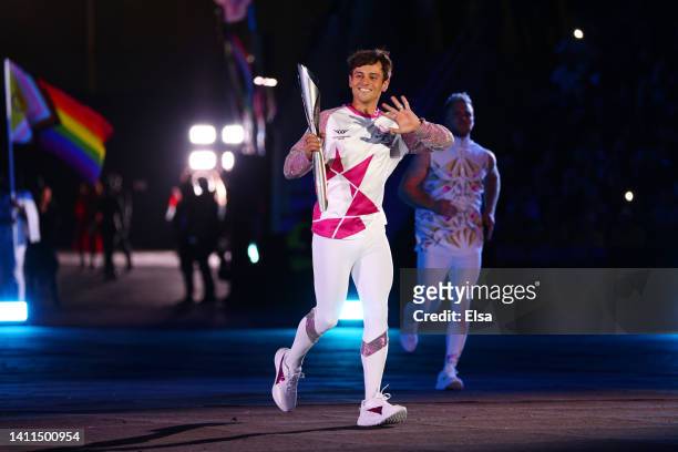 Tom Daley carries the Queen’s Baton during the Opening Ceremony of the Birmingham 2022 Commonwealth Games at Alexander Stadium on July 28, 2022 on...