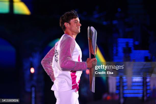 Tom Daley carries the Queen’s Baton during the Opening Ceremony of the Birmingham 2022 Commonwealth Games at Alexander Stadium on July 28, 2022 on...