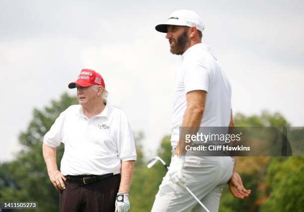 Former U.S. President Donald Trump looks on as Dustin Johnson of 4 Aces GC plays his shot from the seventh tee during the pro-am prior to the LIV...