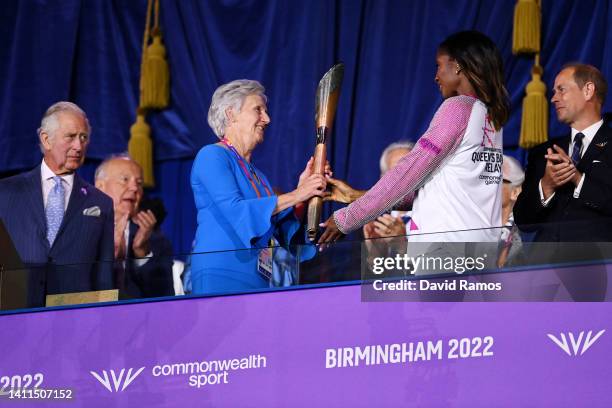 Denise Lewis hands over the Queen’s Baton to Dame Louise Martin during the Opening Ceremony of the Birmingham 2022 Commonwealth Games at Alexander...