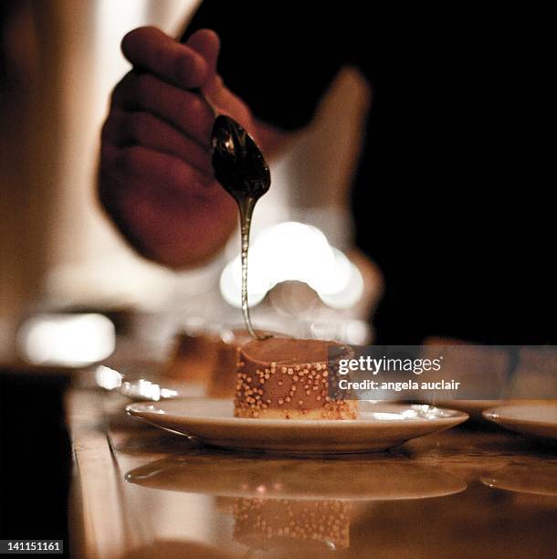 chef dripping caramel sauce - mont tremblant stock pictures, royalty-free photos & images