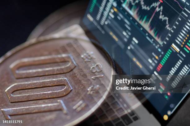 cash yen coins and stock market indicators - yen symbol stock pictures, royalty-free photos & images