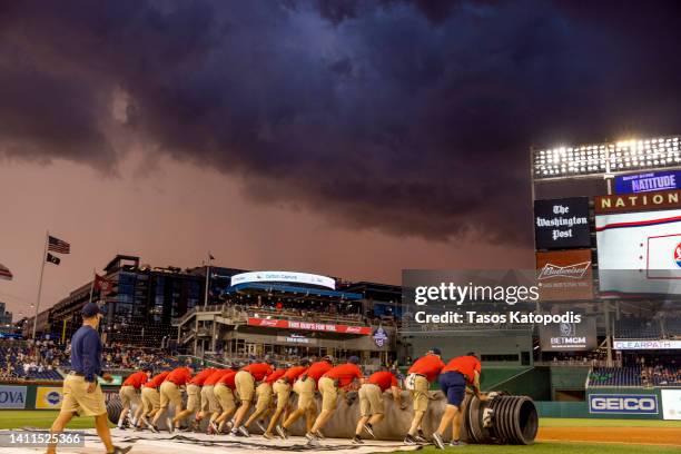 Grounds crews cover the field during the rain delay at the Congressional Baseball Game for Charity at Nationals Park July 28, 2022 at Nationals Park...