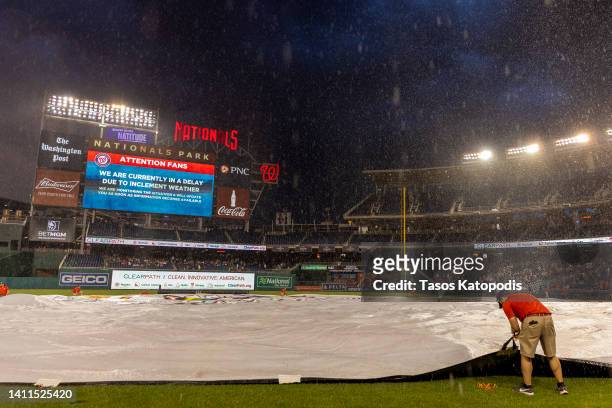 Grounds crews cover the field during the rain delay at the Congressional Baseball Game for Charity at Nationals Park July 28, 2022 at Nationals Park...
