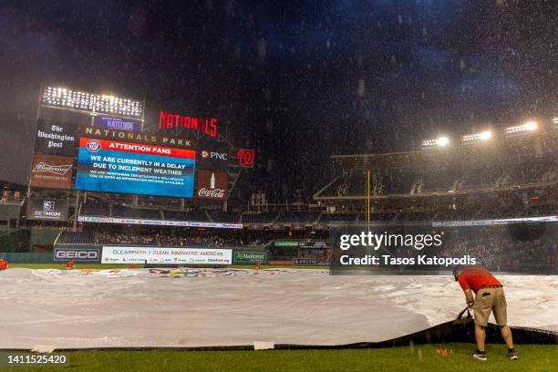 Grounds crews cover the field during the rain delay at the Congressional Baseball Game for Charity at Nationals Park July 28, 2022 at Nationals Park...