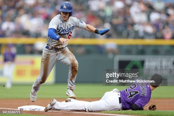 Trea Turner of the Los Angeles Dodgers scores on a fielding error against the Colorado Rockies in the first inning at Coors Field on July 28, 2022 in...