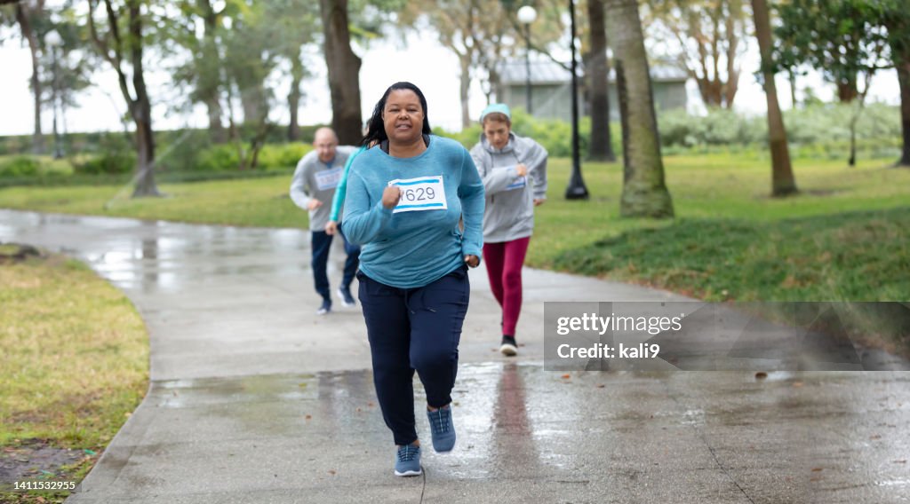 Mature African-American woman running in race