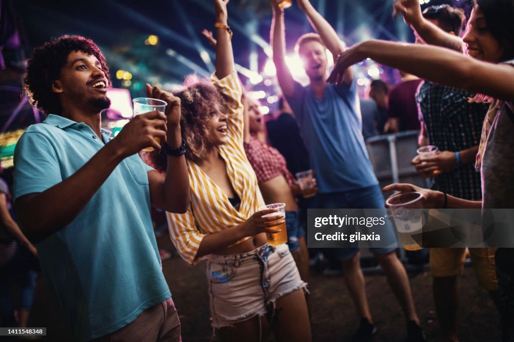 Young people dancing at a concert.