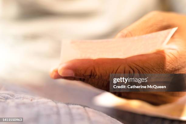 lottery mania: black female holding lottery ticket - kansspel stockfoto's en -beelden