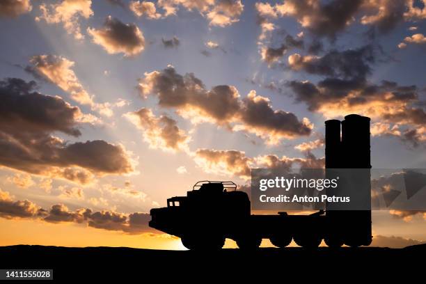 air defence system on the background of sunset sky - nuclear weapon stock pictures, royalty-free photos & images