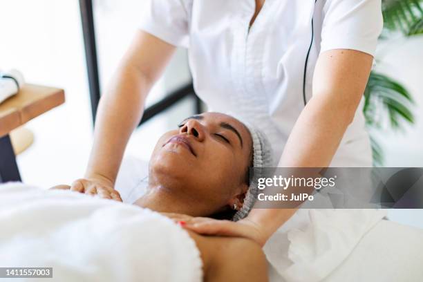 cosmetologist making face massage at home - images of massage rooms 個照片及圖片檔