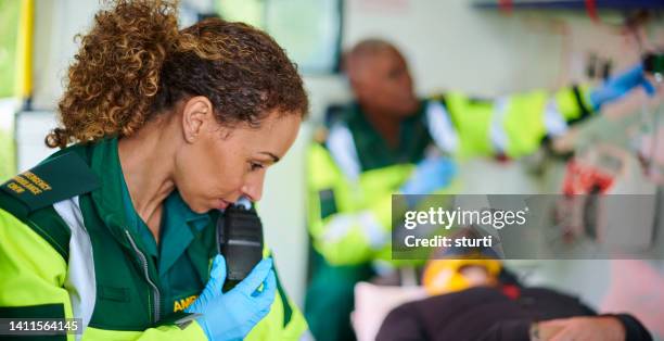 ambulance paramedics with casualty - walkie talkie imagens e fotografias de stock