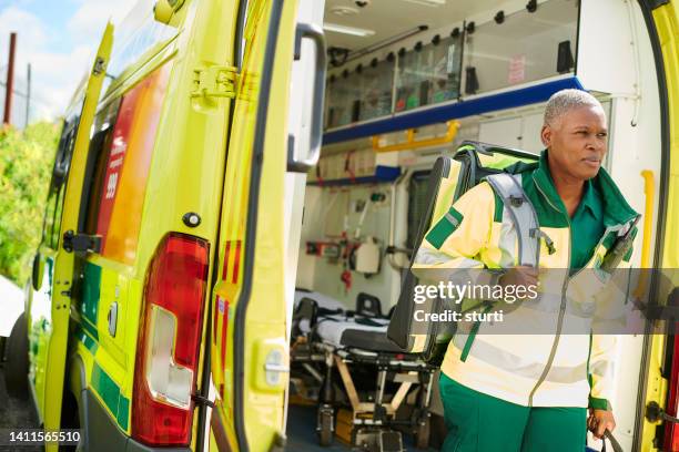 ambulance paramedic arriving at scene - paramedic stock pictures, royalty-free photos & images