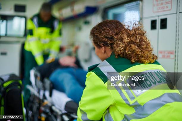 personal de ambulancia cargando ambulancia - técnicos-en-emergencias-médicas fotografías e imágenes de stock