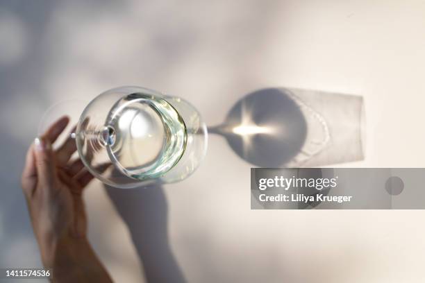 reflection of woman's hand with a glass of wine. - empty glass stock pictures, royalty-free photos & images