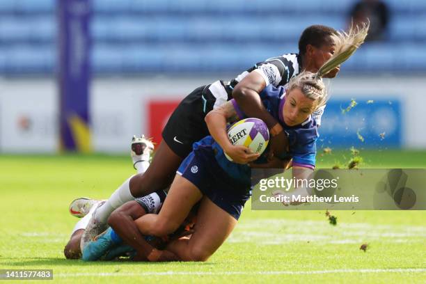 Chloe Rollie of Team Scotland is tackled by Raijieli Daveua of Team Fiji during the Women's Rugby Sevens Pool B match between Team Fiji and Team...