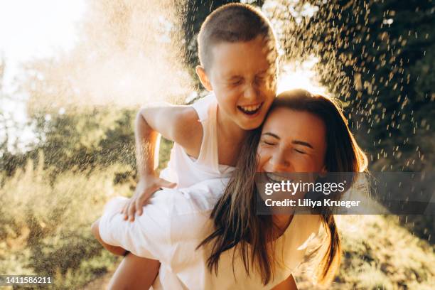 happy mom and son in sunset rays of light. - family time stock pictures, royalty-free photos & images