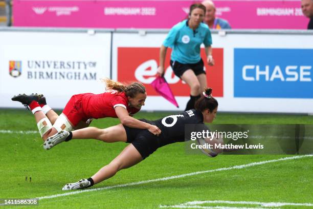 Michaela Blyde of Team New Zealand holds off Krissy Scurfield of Team Canada to score their side's second try during the Women's Rugby Sevens Pool A...