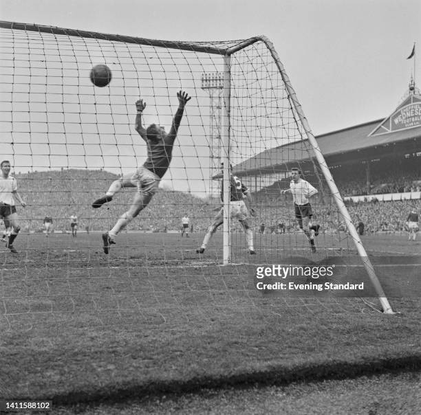 British footballer David Gaskell, Manchester United goalkeeper, dives but fails to make the save in the FA Cup Semi Final between Tottenham Hotspur...